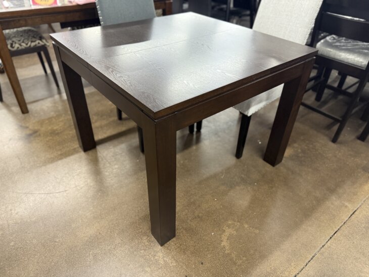 Expandable espresso wood dining table with square-to-large-square transformation.