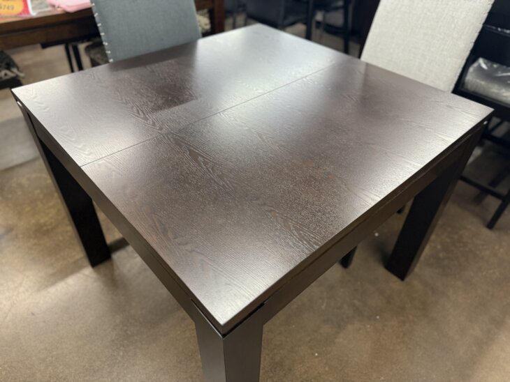 Expandable espresso wood dining table with square-to-large-square transformation.